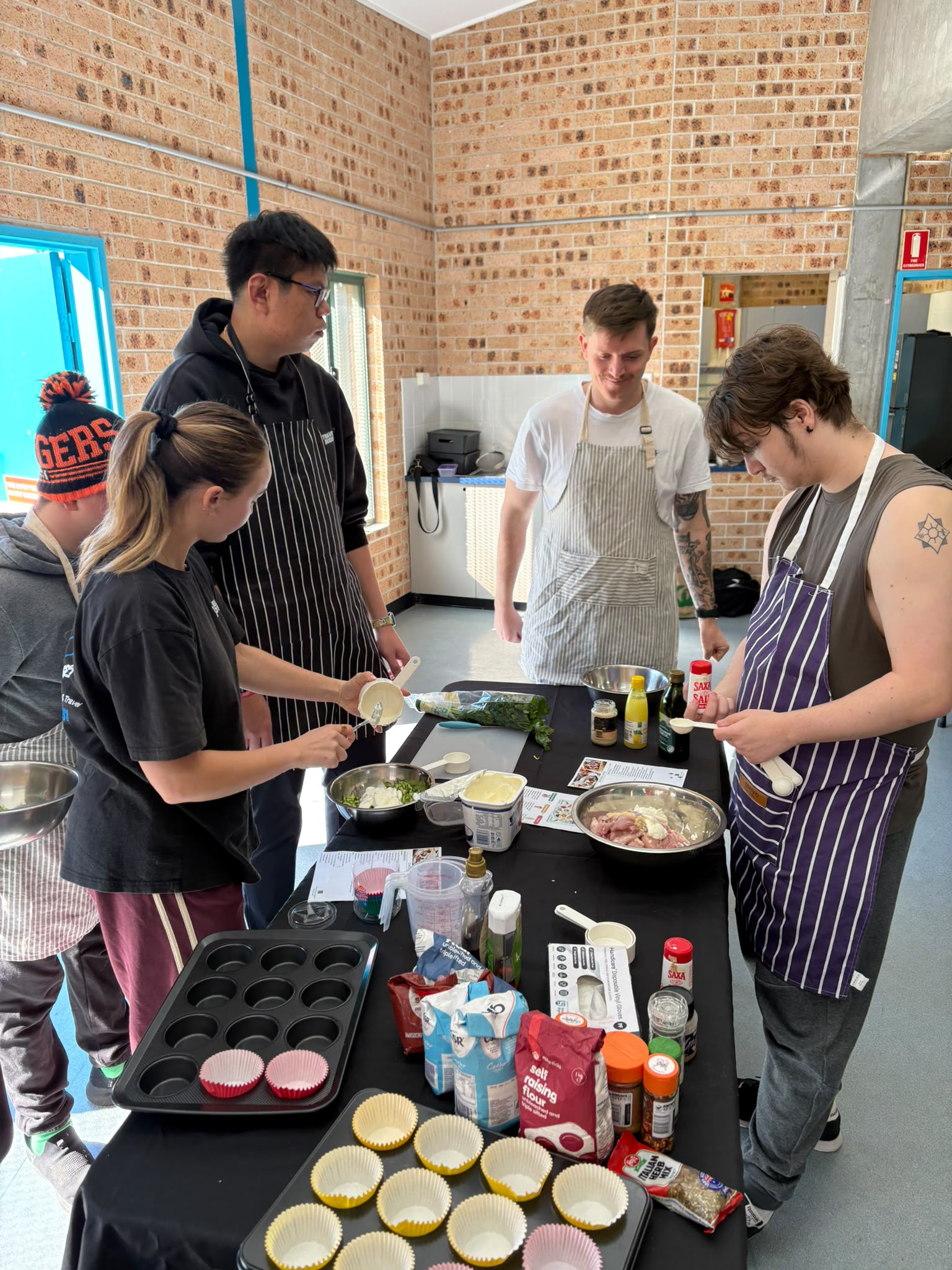 Guests cooking together at a Travel Buddy Adventures cooking class