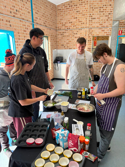 Guests cooking together at a Travel Buddy Adventures cooking class